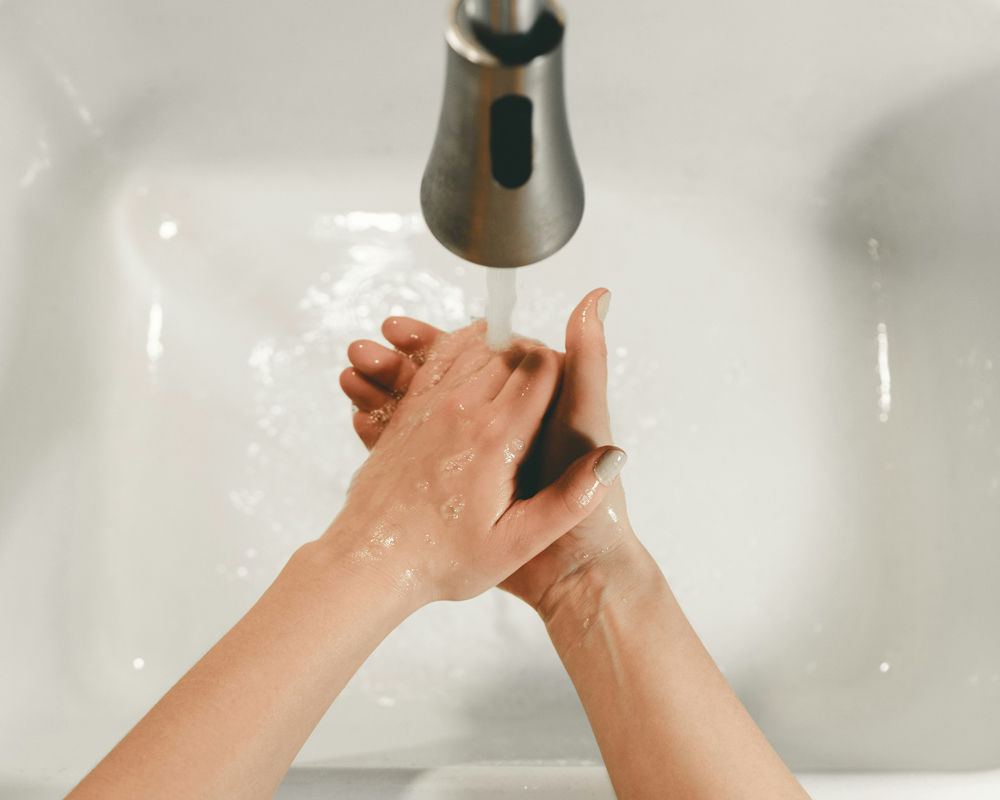 Washing hands under spicket