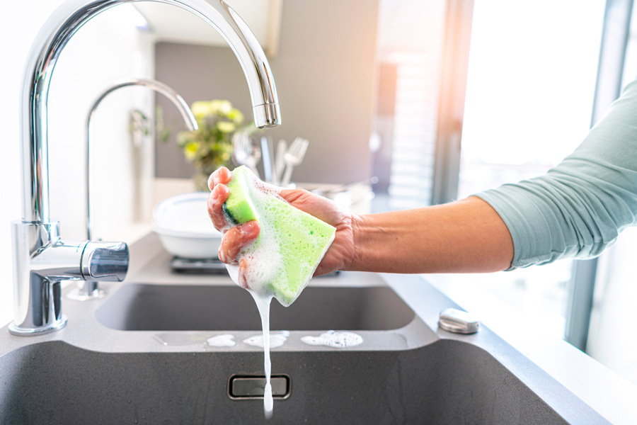 Washing pots in kitchen sink