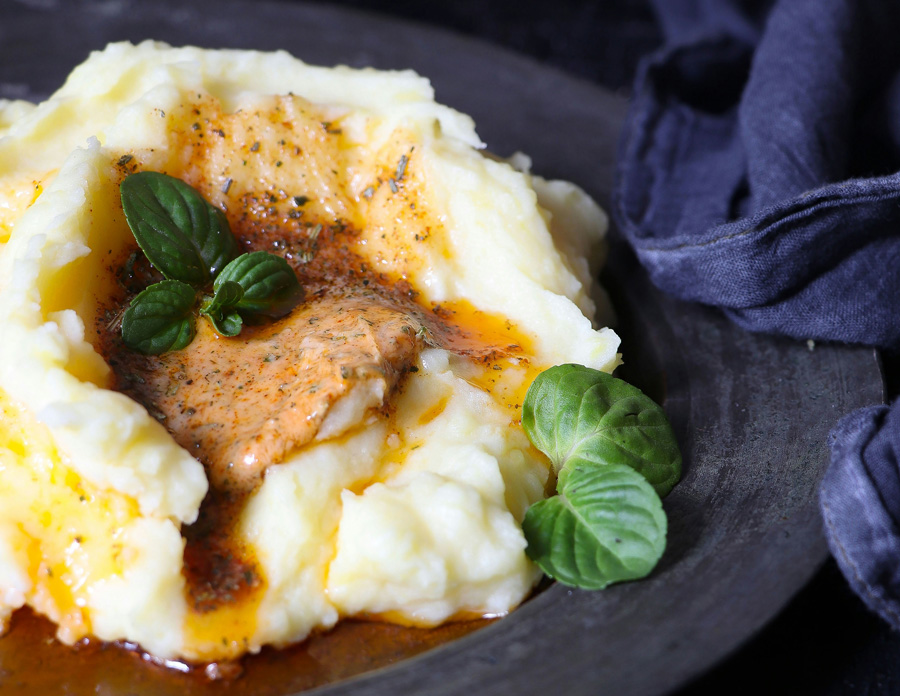 Mashed potatoes in gravy with basil